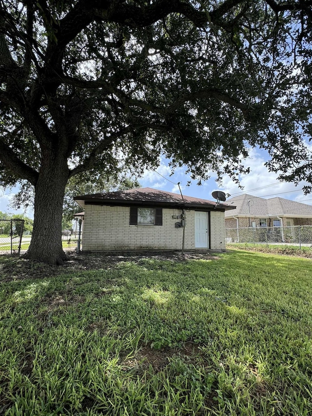 back of property featuring a yard