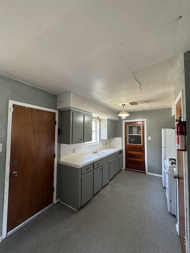 kitchen featuring gray cabinetry and white appliances