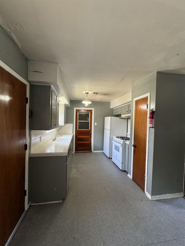 kitchen featuring white appliances and sink