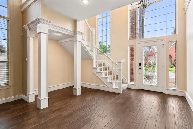 entrance foyer with ornate columns and a high ceiling