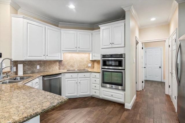 kitchen featuring white cabinets, appliances with stainless steel finishes, dark hardwood / wood-style floors, and sink