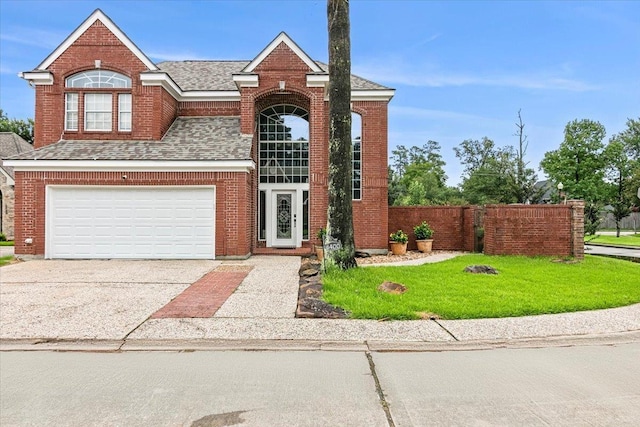 front of property featuring a front lawn and a garage