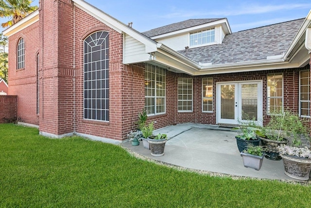 rear view of house with a yard and a patio area