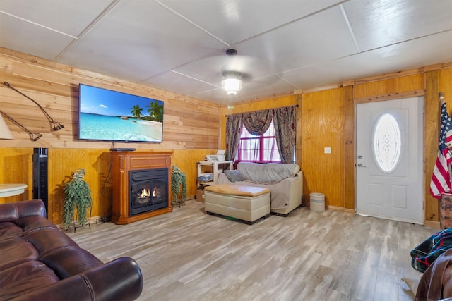 living room with wood-type flooring and wooden walls