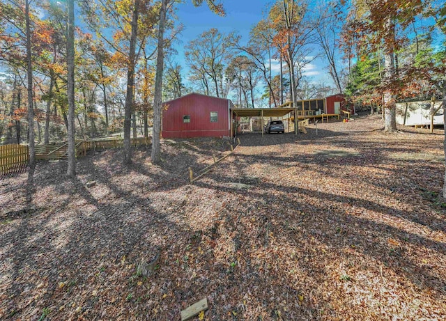 view of yard with an outbuilding and a carport