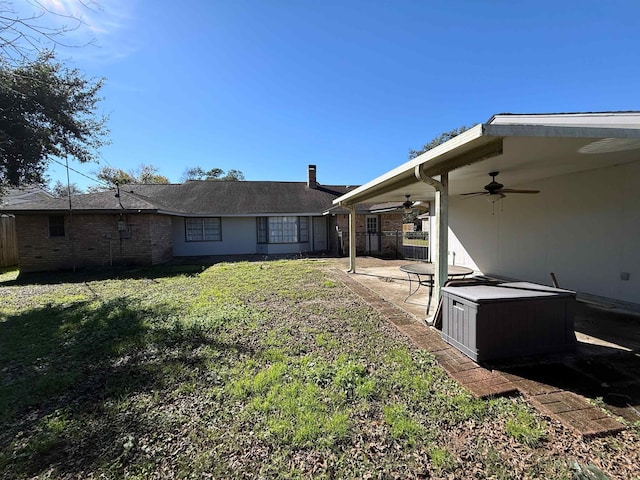 view of yard featuring ceiling fan and a patio area