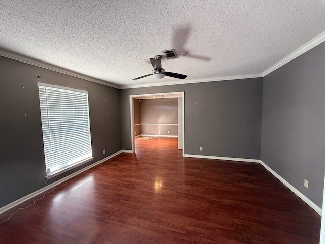 spare room featuring ceiling fan, dark hardwood / wood-style flooring, crown molding, and plenty of natural light