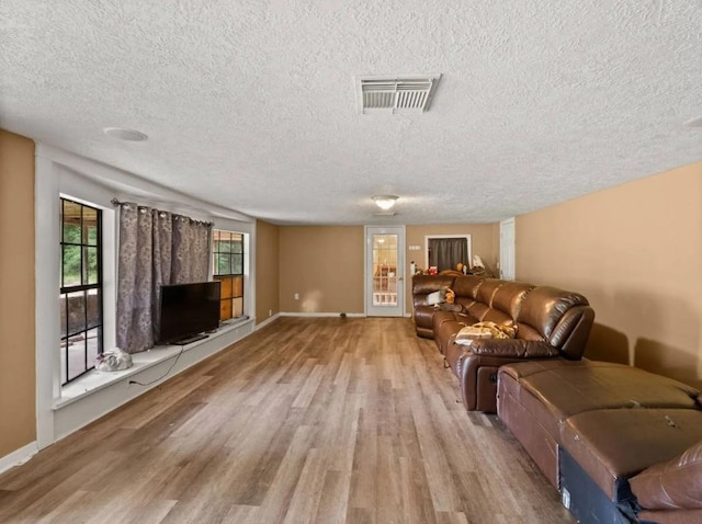 19995 S Fm 92, Fred, TX 77616 - living area with wood finished floors and a textured ceiling