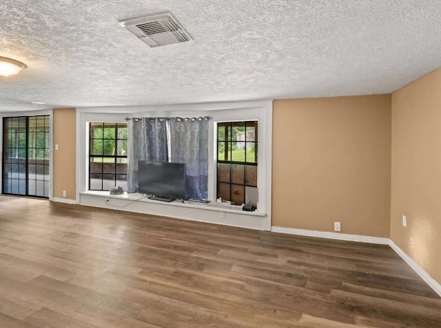 19995 S Fm 92, Fred, TX 77616 - unfurnished living room featuring wood finished floors and a textured ceiling