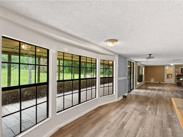 19995 S Fm 92, Fred, TX 77616 - unfurnished sunroom featuring a textured ceiling and wood finished floors