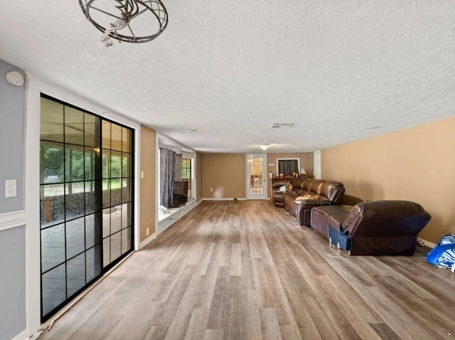 19995 S Fm 92, Fred, TX 77616 - unfurnished living room with a textured ceiling and wood finished floors