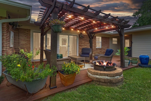 935 Nichols Dr, Beaumont, TX 77706 - patio terrace at dusk with an outdoor fire pit, a pergola, and a wooden deck