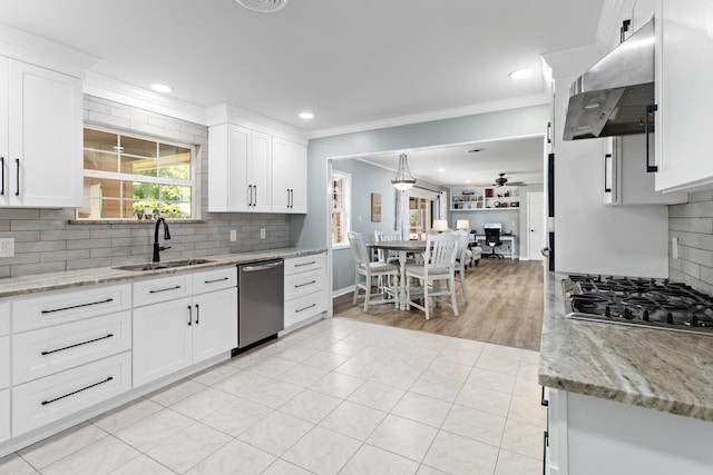 935 Nichols Dr, Beaumont, TX 77706 - kitchen with appliances with stainless steel finishes, extractor fan, decorative backsplash, white cabinets, and recessed lighting