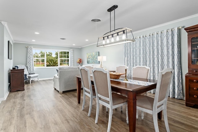 935 Nichols Dr, Beaumont, TX 77706 - dining area with ornamental molding, wood finished floors, and recessed lighting