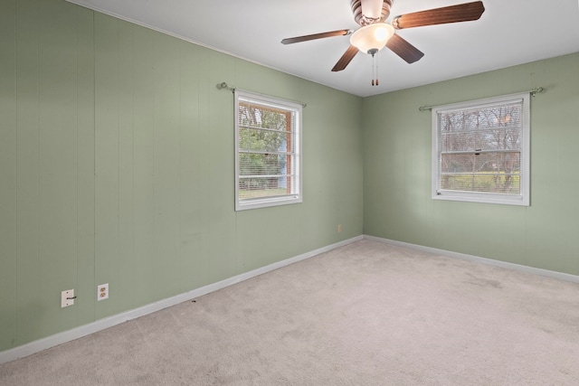 empty room featuring baseboards, carpet, and a ceiling fan