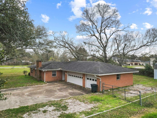 view of property exterior with fence, a yard, concrete driveway, brick siding, and a chimney