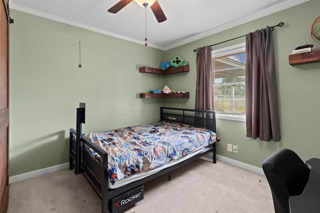 carpeted bedroom with baseboards, a ceiling fan, and crown molding