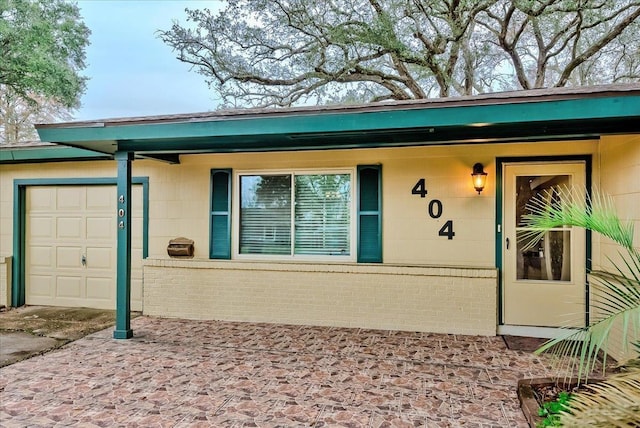 view of exterior entry featuring a garage