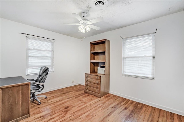 office space featuring light hardwood / wood-style floors and ceiling fan