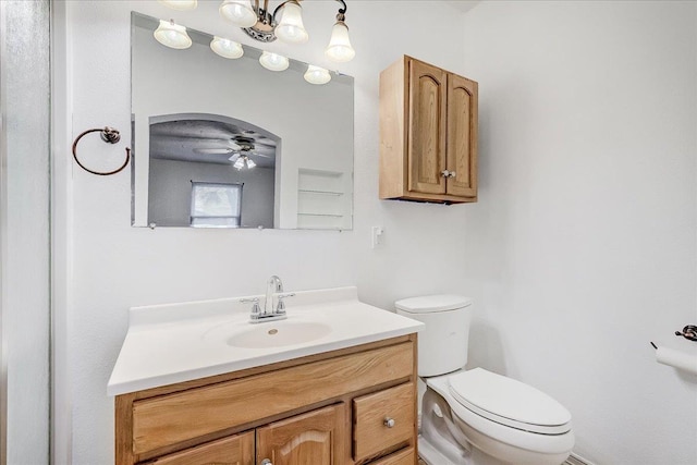 bathroom with ceiling fan, vanity, and toilet