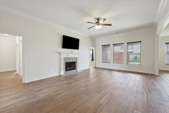 4406 Sequoia, Orange, TX 77630 - unfurnished living room with a ceiling fan, light wood-style flooring, a high end fireplace, crown molding, and baseboards