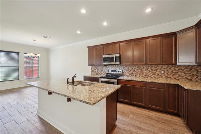 4406 Sequoia, Orange, TX 77630 - kitchen featuring a sink, appliances with stainless steel finishes, light wood-style floors, light stone countertops, and ornamental molding
