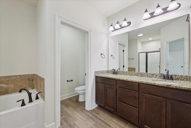 4406 Sequoia, Orange, TX 77630 - bathroom with a garden tub, double vanity, wood finished floors, toilet, and baseboards