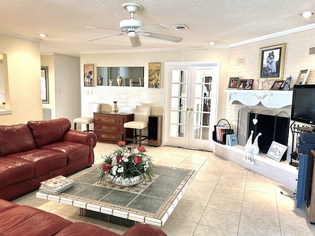 tiled living room featuring crown molding, french doors, ceiling fan, and a textured ceiling