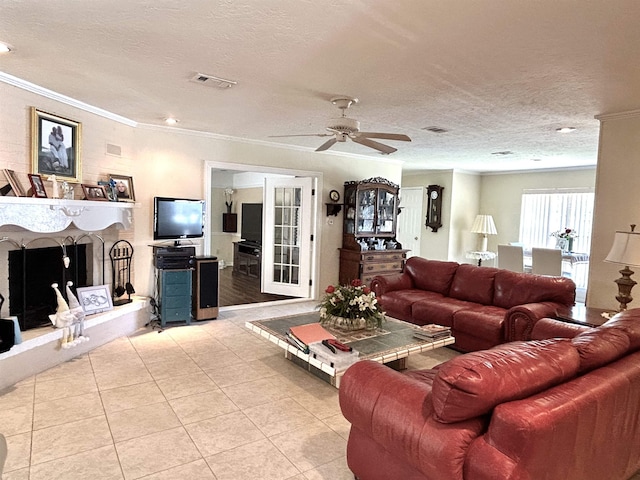 living room with ceiling fan, light tile patterned flooring, a textured ceiling, and ornamental molding