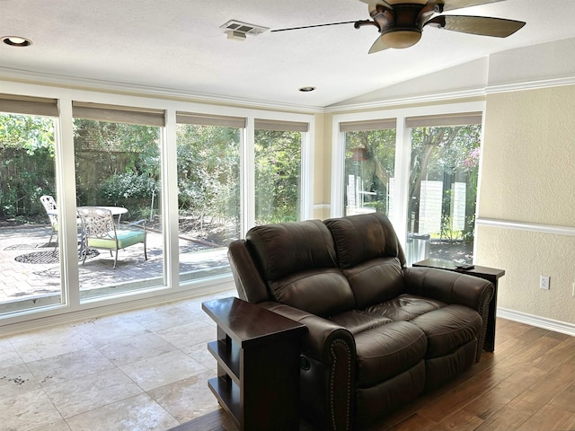 sunroom featuring ceiling fan and vaulted ceiling