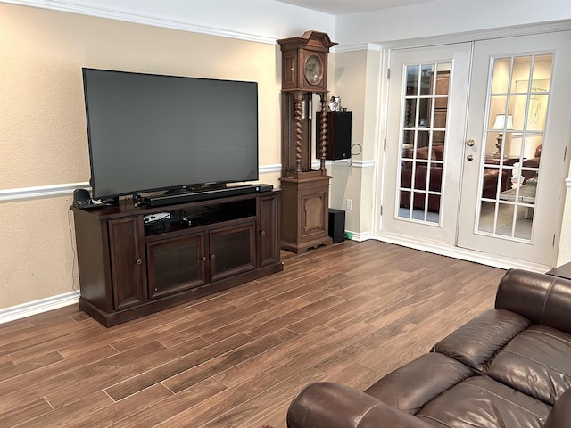 living room featuring french doors, crown molding, and wood-type flooring