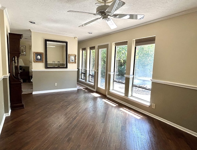 unfurnished room with ceiling fan, dark hardwood / wood-style flooring, a textured ceiling, and ornamental molding