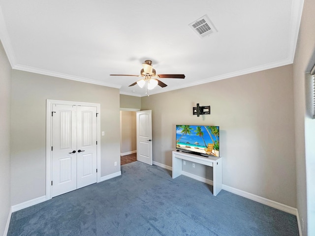 interior space featuring carpet floors, ceiling fan, and crown molding