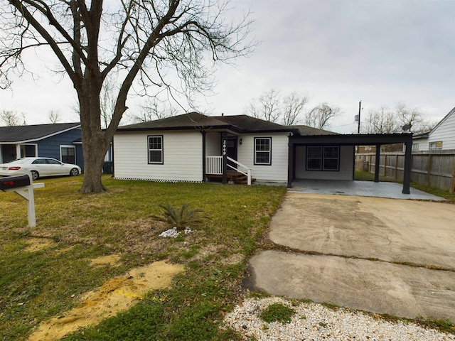 ranch-style house with a carport and a front lawn