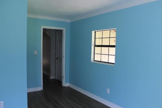 unfurnished room featuring dark hardwood / wood-style floors and crown molding