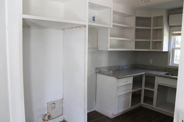 pantry featuring an AC wall unit and sink