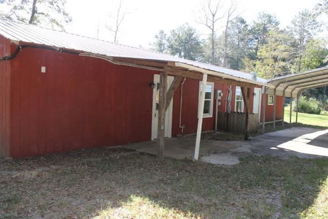 view of side of home with a carport