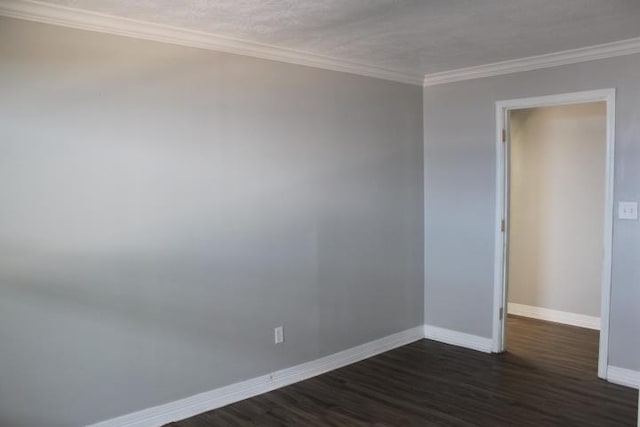 empty room with ornamental molding and dark wood-type flooring