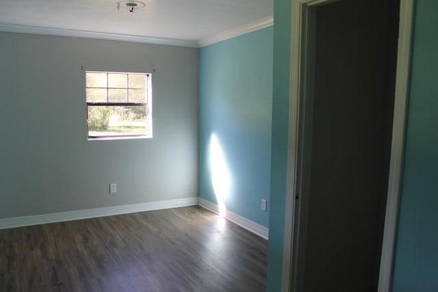 spare room featuring dark hardwood / wood-style floors and ornamental molding