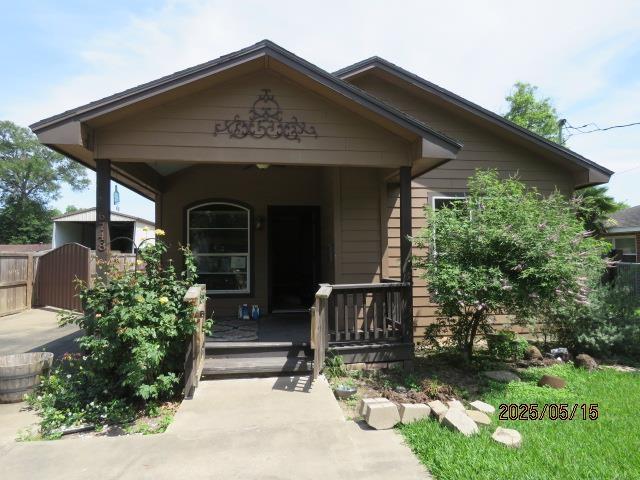 6748 Jefferson Blvd, Groves, TX 77619 - view of front of property with a porch and a gate