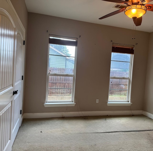 6748 Jefferson Blvd, Groves, TX 77619 - unfurnished room featuring healthy amount of natural light, ceiling fan, and carpet flooring