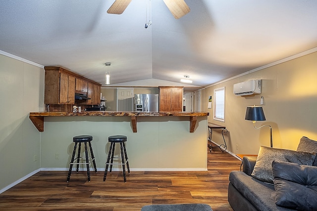 kitchen featuring kitchen peninsula, stainless steel refrigerator with ice dispenser, dark hardwood / wood-style flooring, a breakfast bar, and an AC wall unit