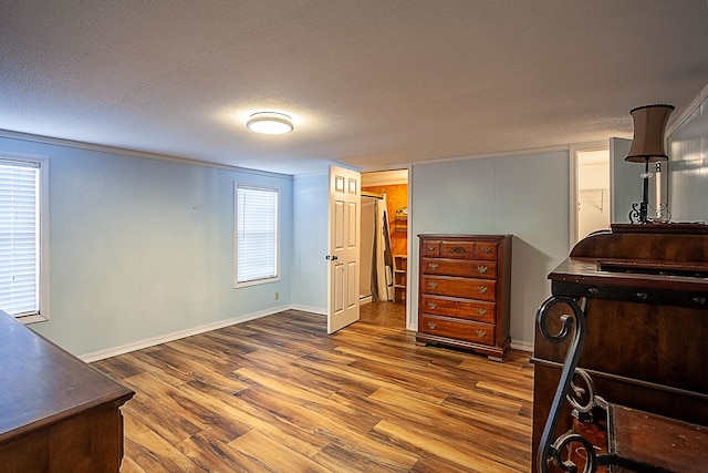 bedroom featuring a textured ceiling, hardwood / wood-style flooring, and a closet