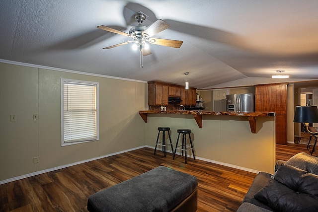 living room featuring ceiling fan, dark hardwood / wood-style flooring, lofted ceiling, and ornamental molding