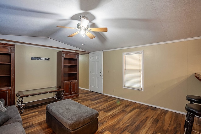 living area with vaulted ceiling, ceiling fan, crown molding, and dark hardwood / wood-style floors