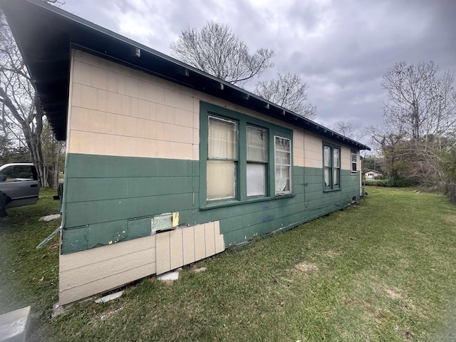 view of property exterior featuring a lawn