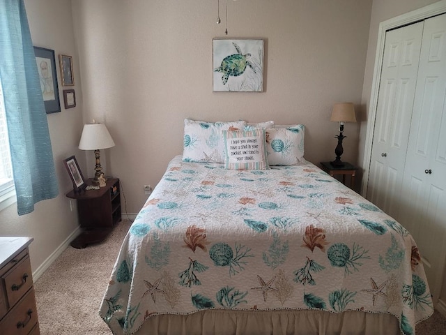 bedroom featuring a closet and light colored carpet