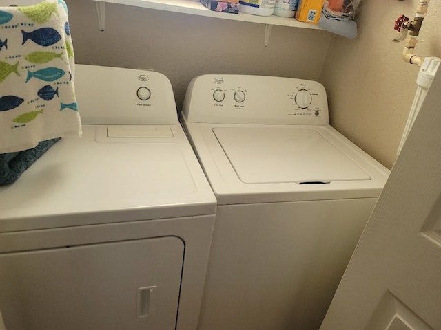 clothes washing area with washer and dryer