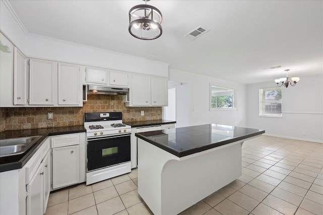 1336 Beagle Rd, Orange, TX 77632 - kitchen featuring white gas stove, under cabinet range hood, decorative backsplash, light tile patterned flooring, and crown molding