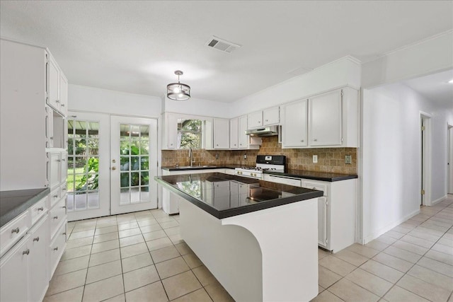 1336 Beagle Rd, Orange, TX 77632 - kitchen featuring gas stove, light tile patterned flooring, and decorative backsplash